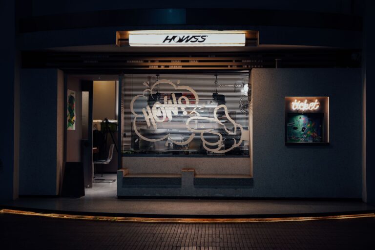 Illuminated business signage on a shop front, one part of a workplace signage system